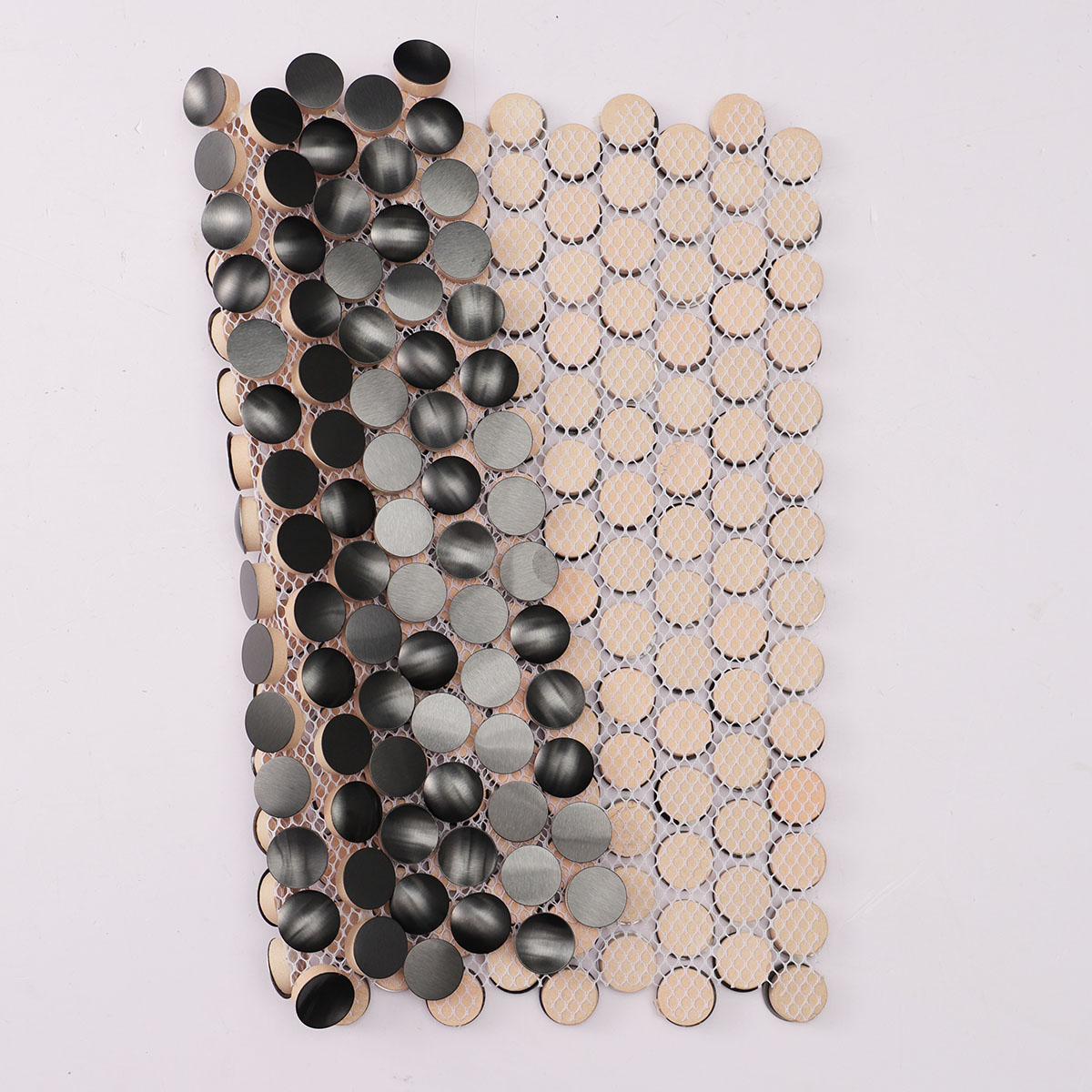 Folded back side of 3D black penny round metal mosaic tiles.