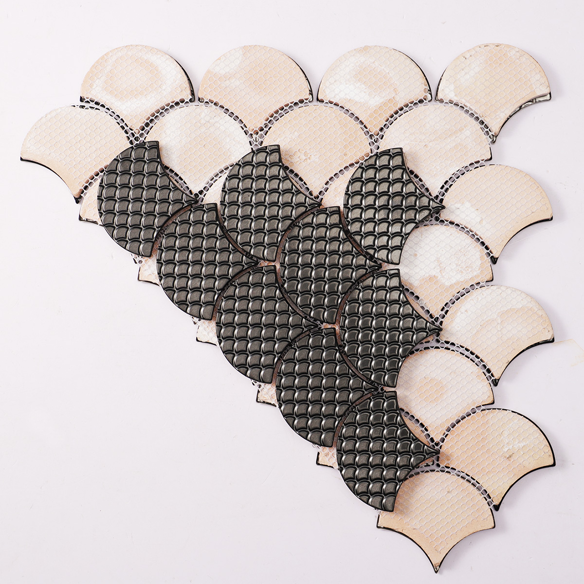 Back side of black metal fish scale pattern mosaic tiles, folded.