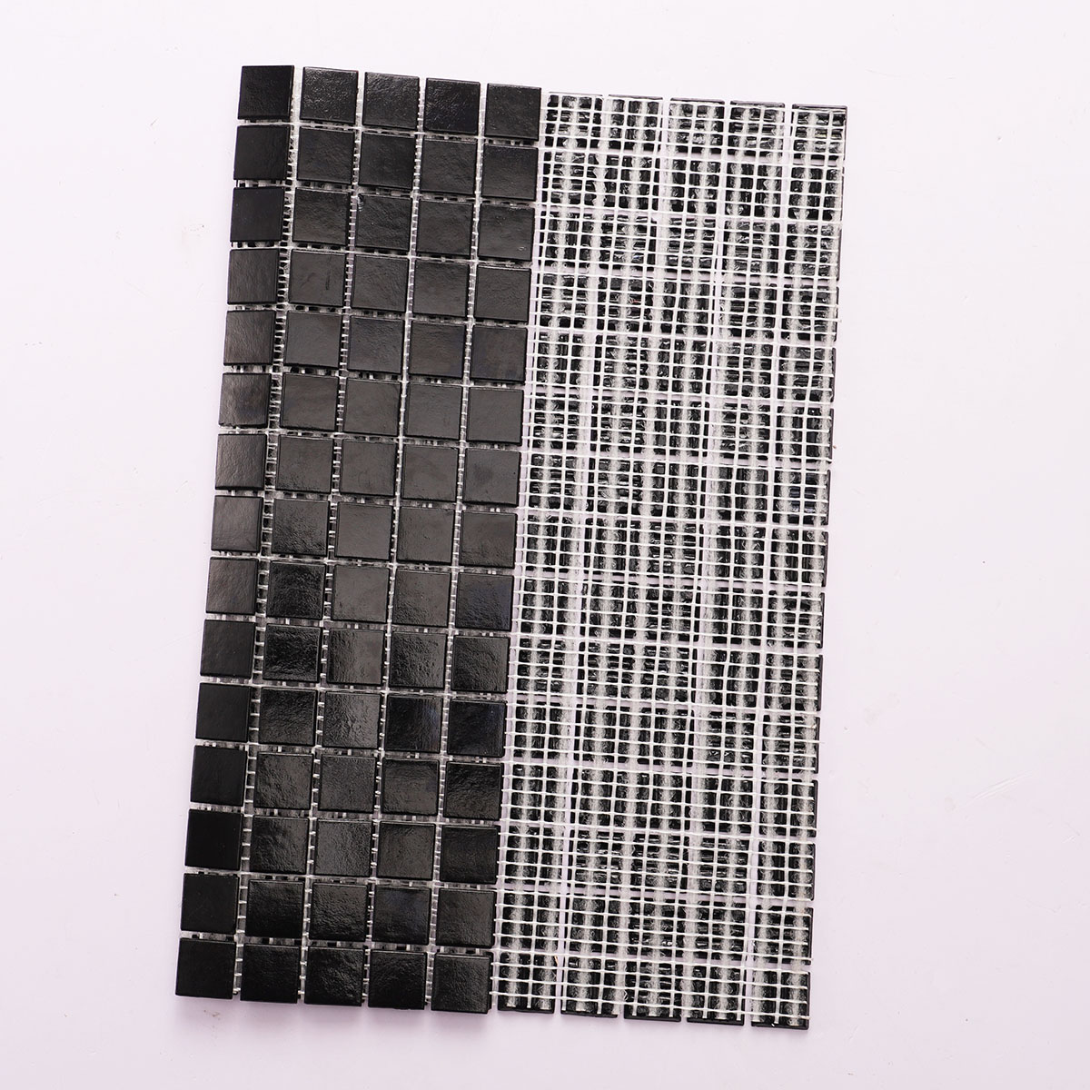 Back side of black fired earth glass square mosaic tiles 20mm x 20mm, folded.