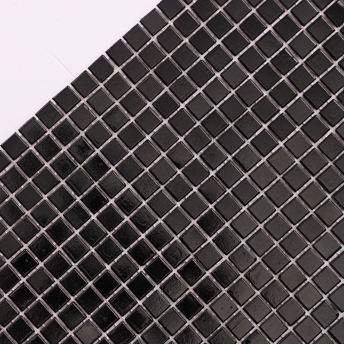 Close-up of black square glass tiny mosaic tiles 10mm x 10mm.