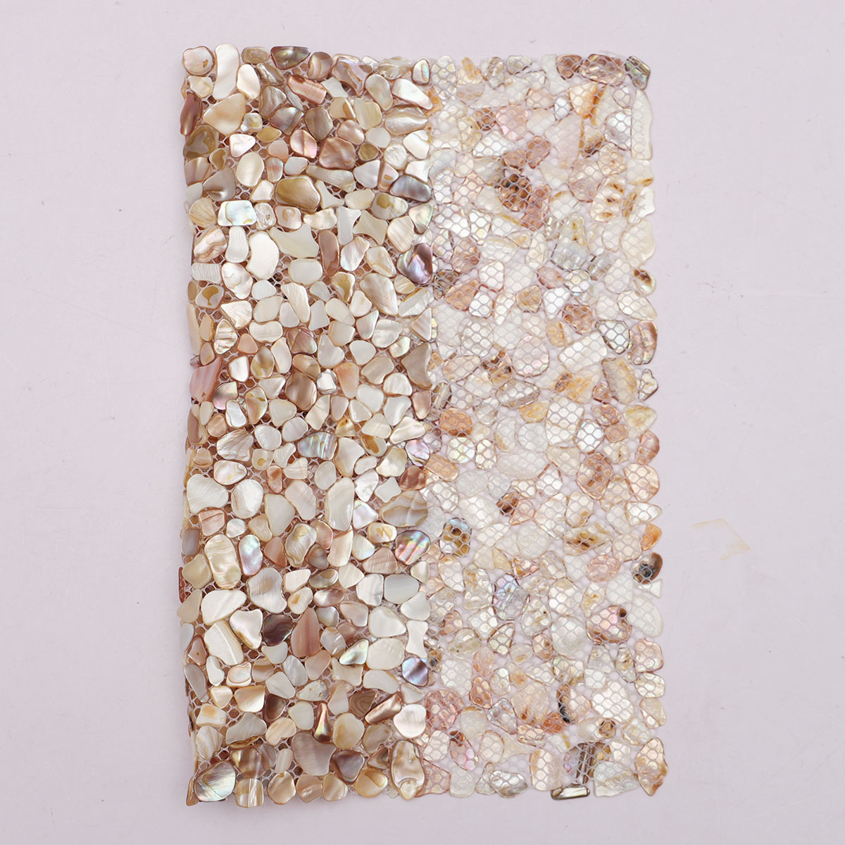 Folded back side of Mother of Pearl random tiny pebble mosaic tiles.