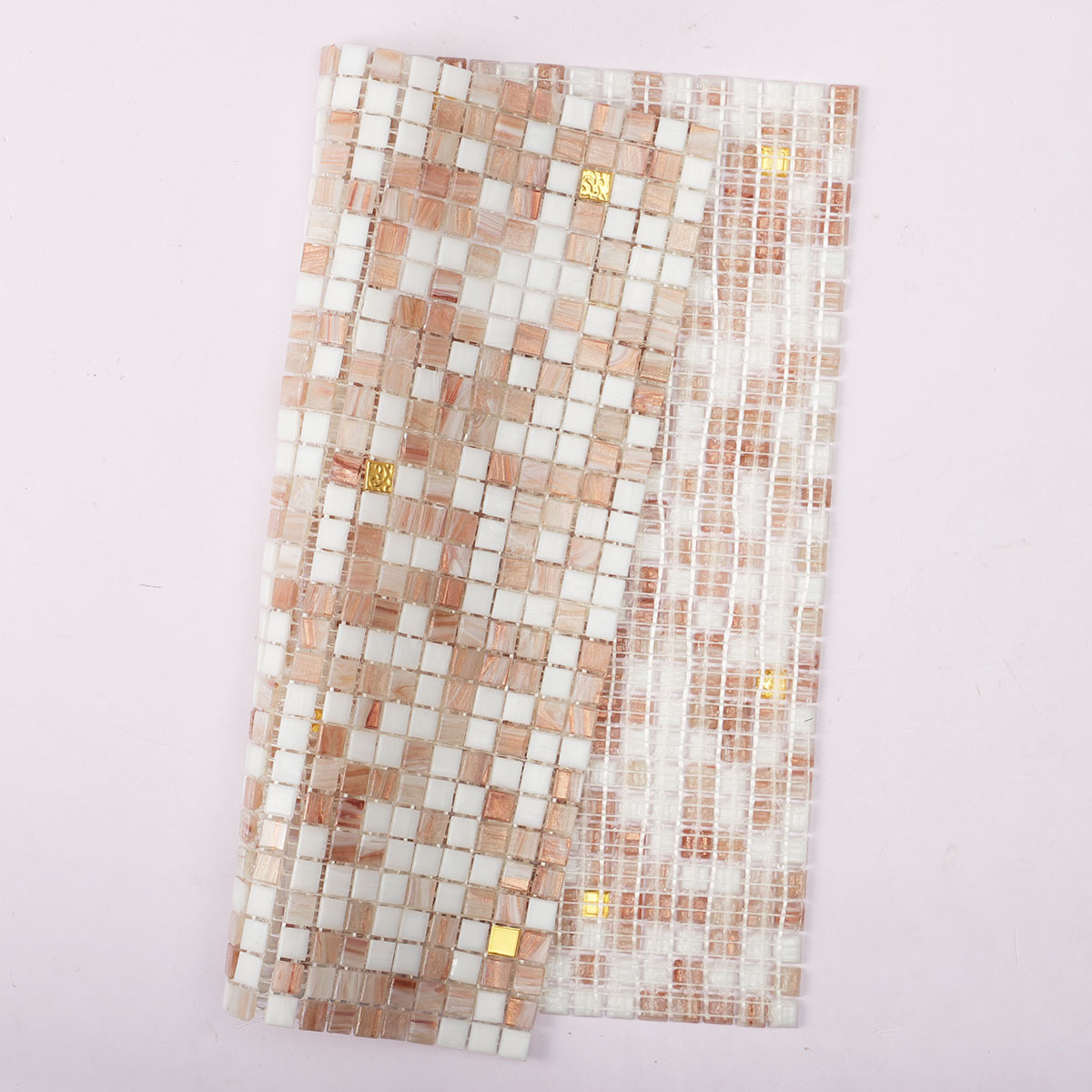 Back side of white and beige tiny glass mosaic tiles with 24K gold, folded.