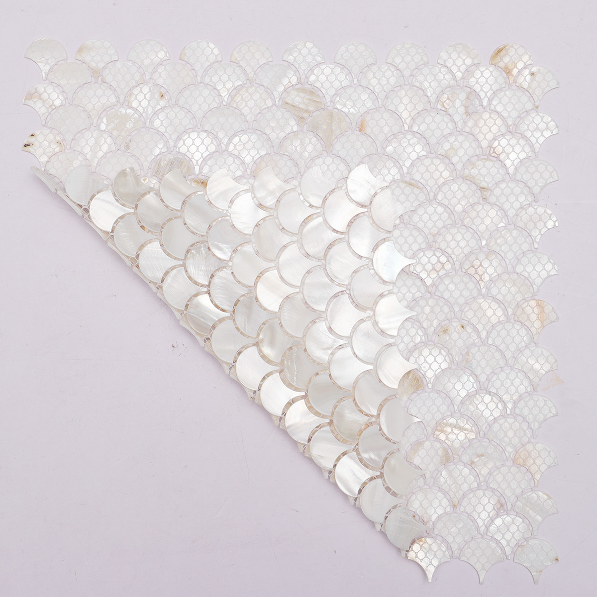 A sheet of mother of pearl mosaic tiles in a fish scale shape