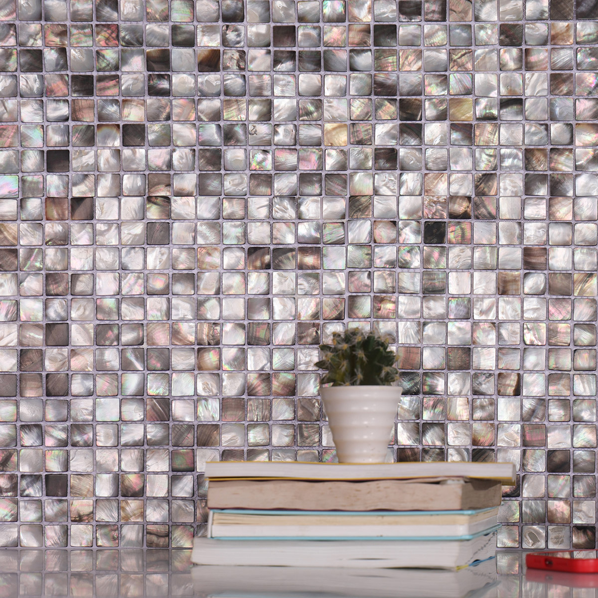 Wall adorned with deep-sea black seashell square pattern mosaic tiles.