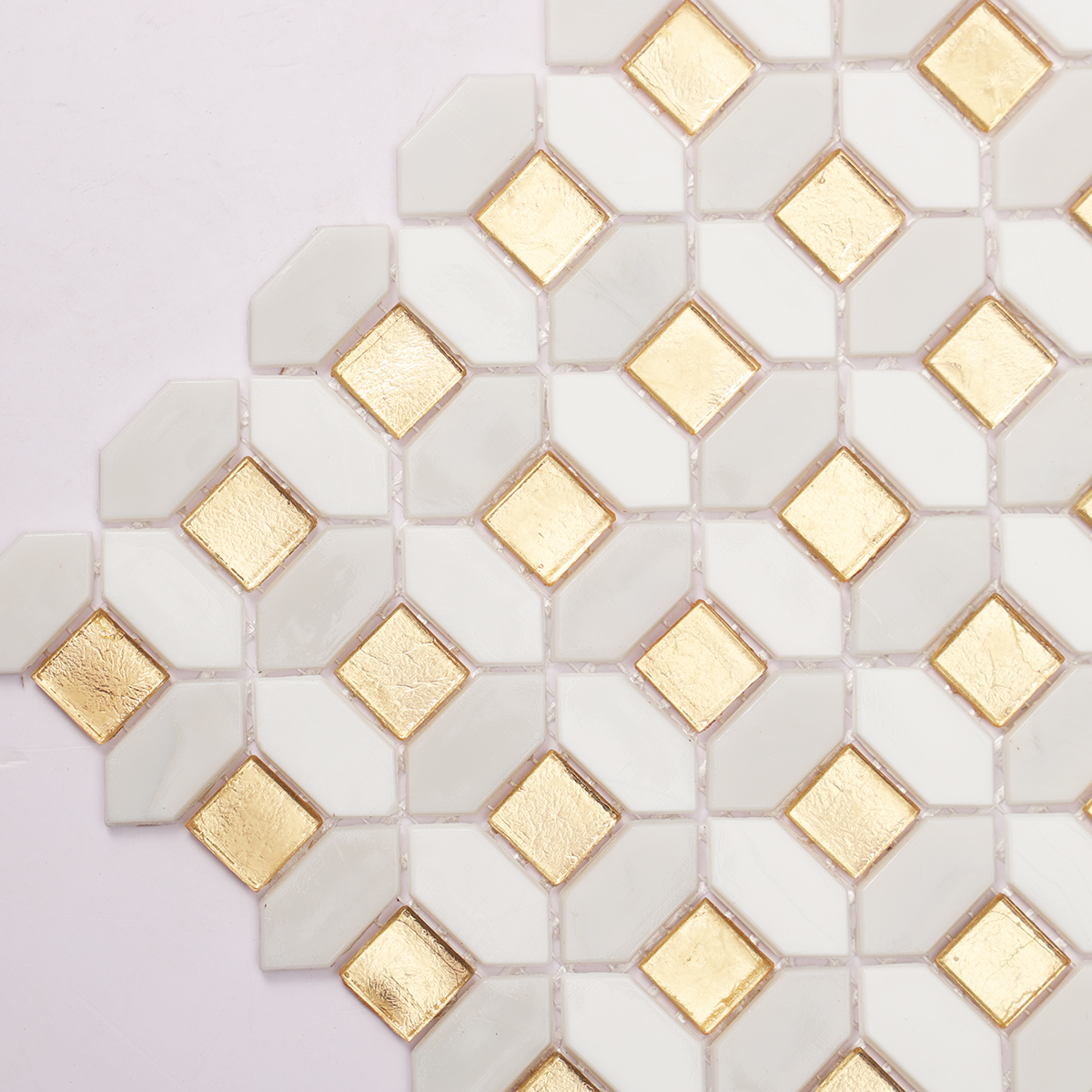 Close-up of gold and white glass mosaic tiles.