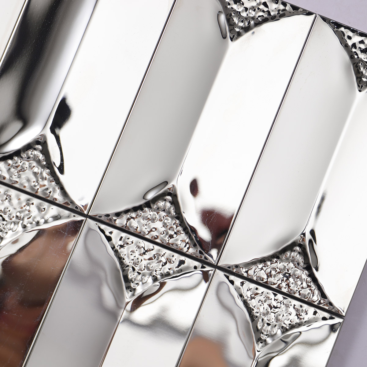 Close-up of the middle section of 3D glossy silver rectangle metal mosaic tiles