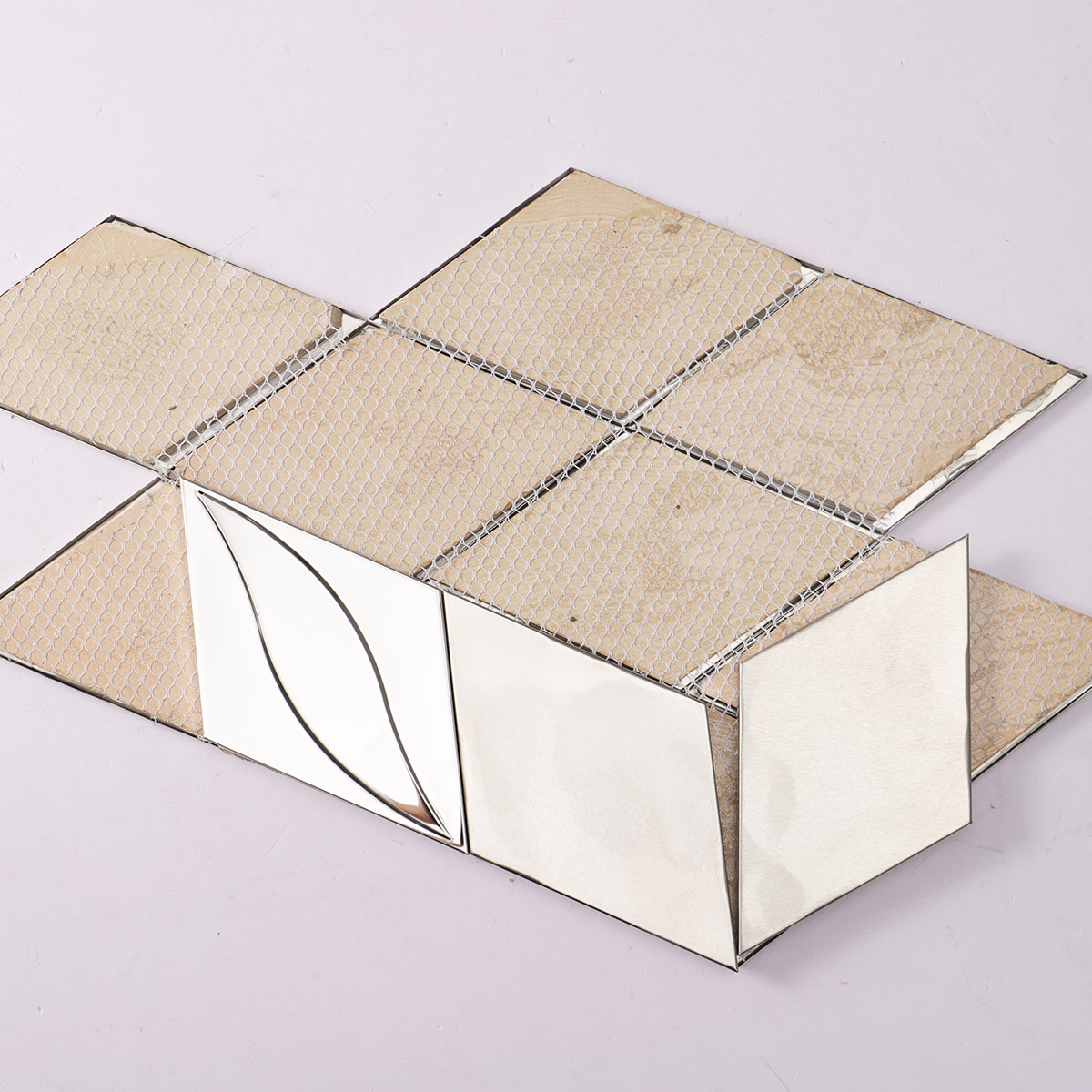 Back side of mirror silver diamond stainless steel mosaic, showing fold