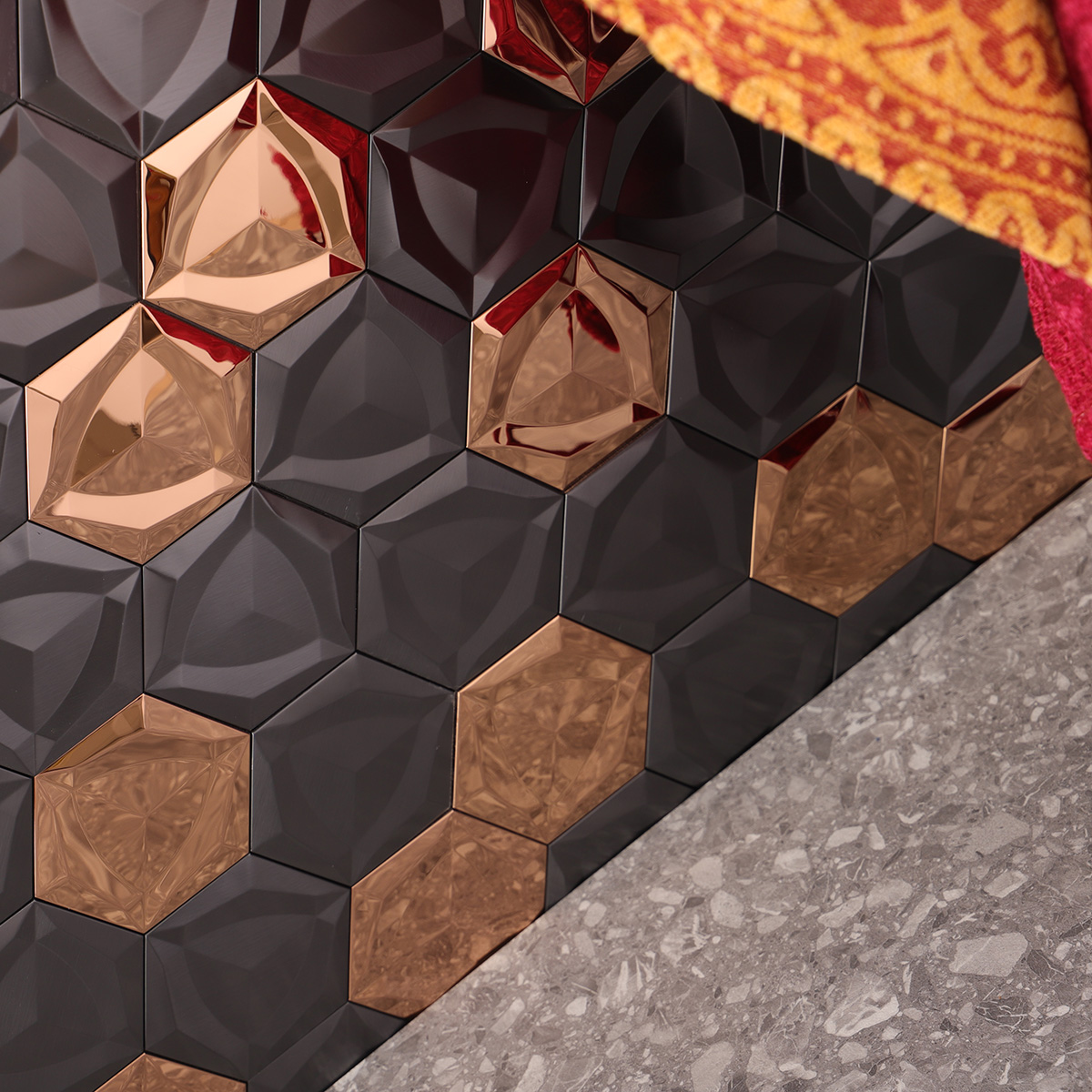 Close-up of 3D black and gold hexagon metal mosaic tiles,