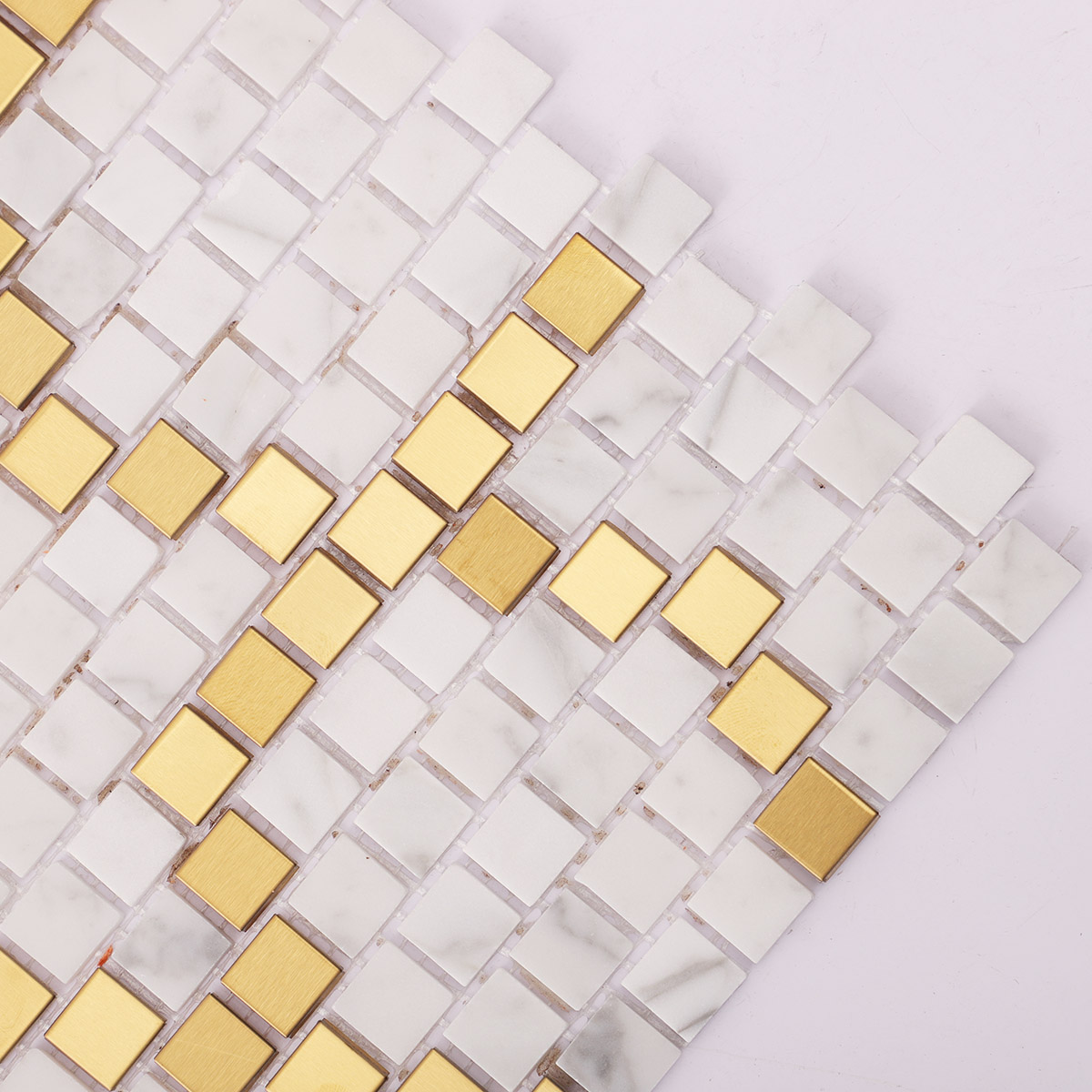 Close-up of the side of metal and white marble pixel art mosaic tiles