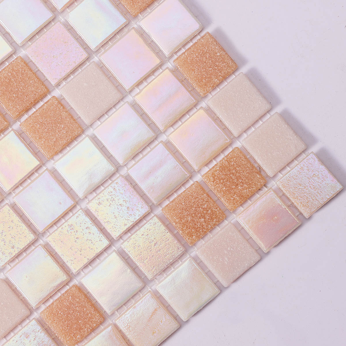 Side close-up of light pink and yellow glass mosaic tiles