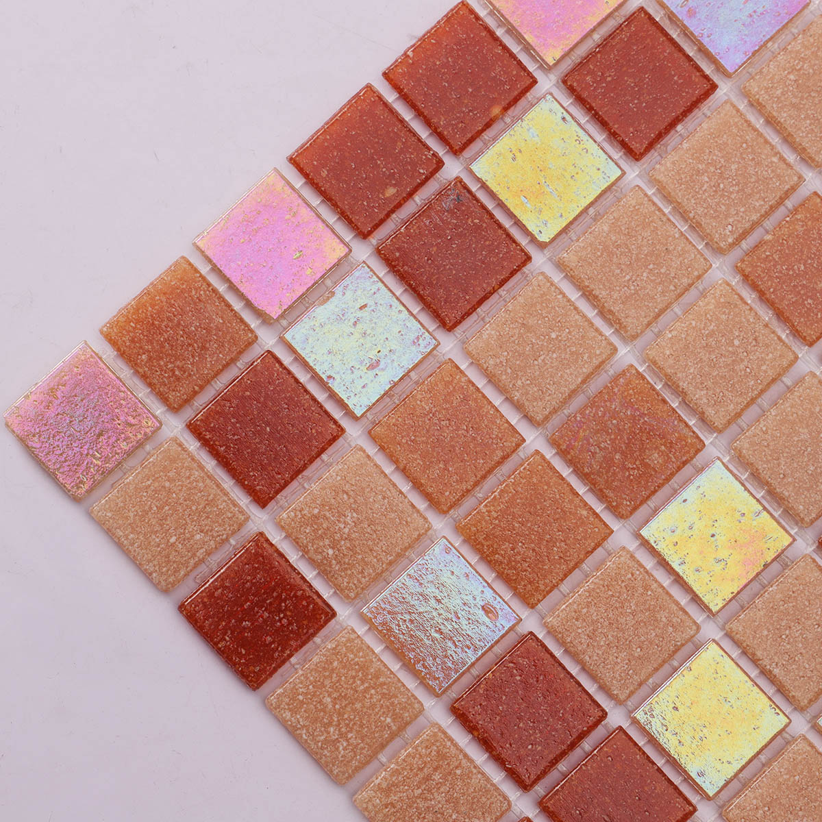 Close-up of orange and yellow mixed glass mosaic tiles, showing size