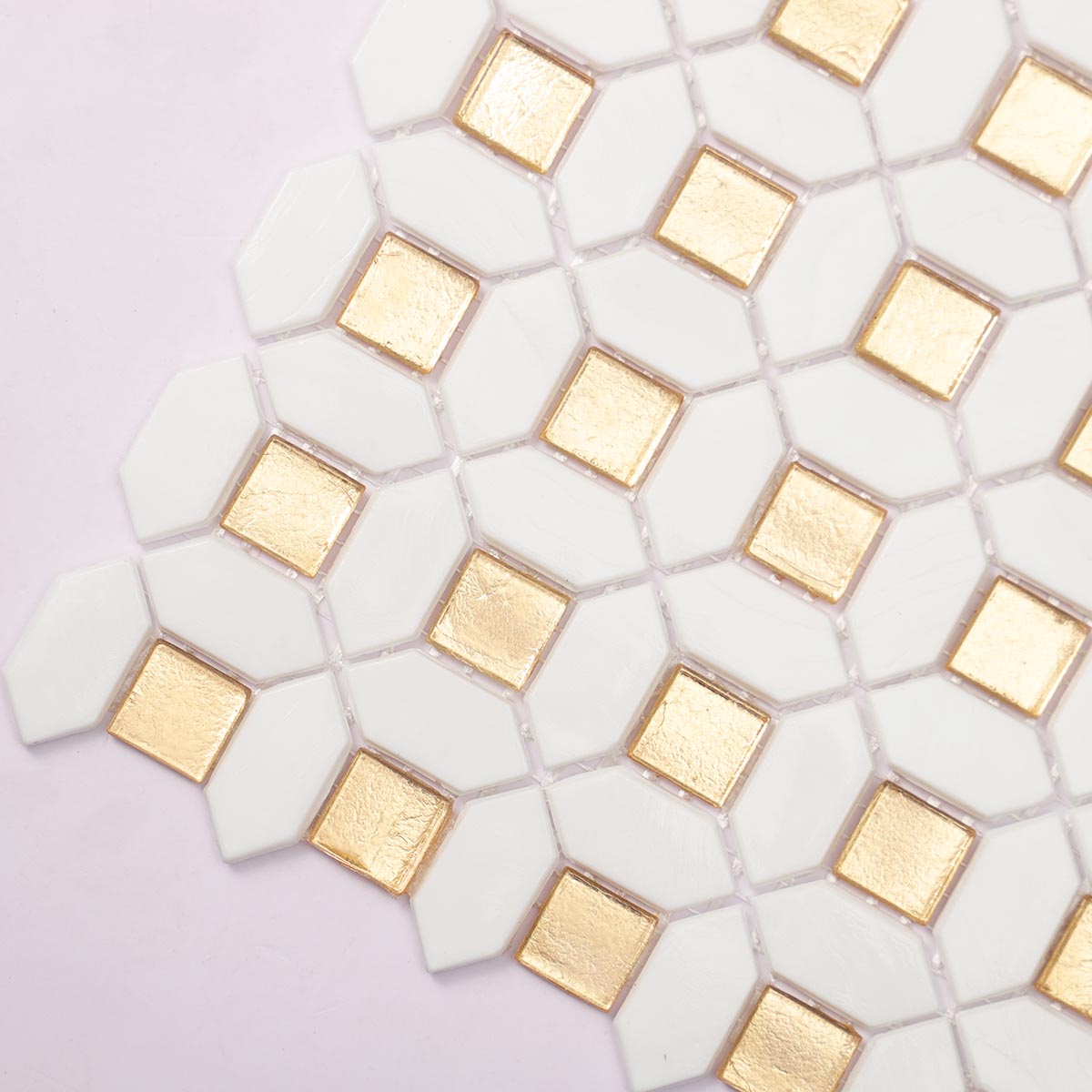 Close-up side view of glossy gold and white glass mosaic tiles