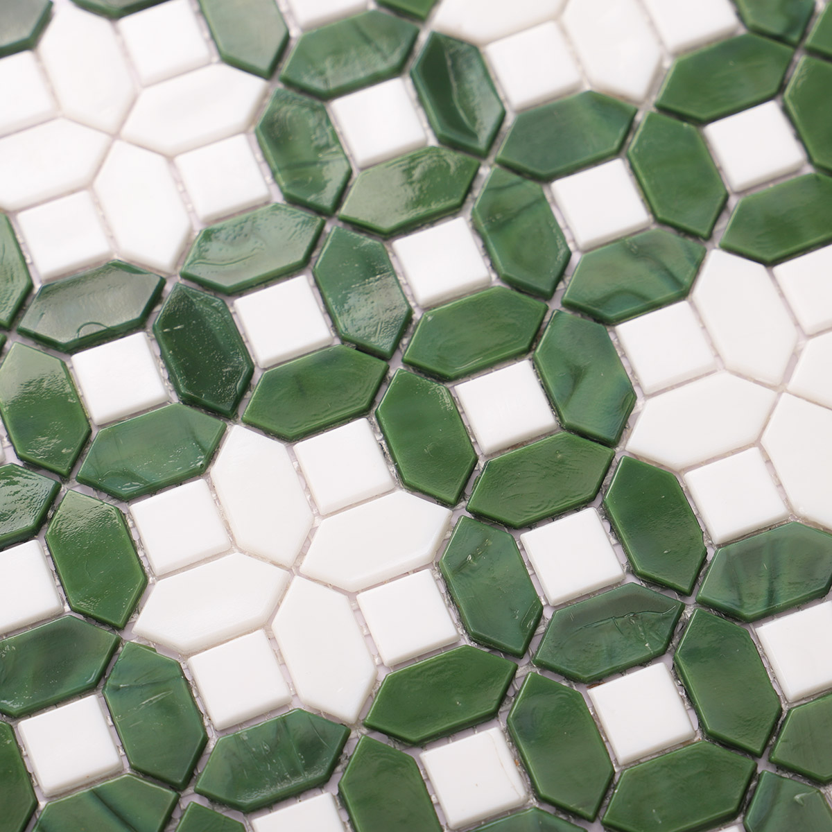 Close-up view of white and green picket glass mosaic tile