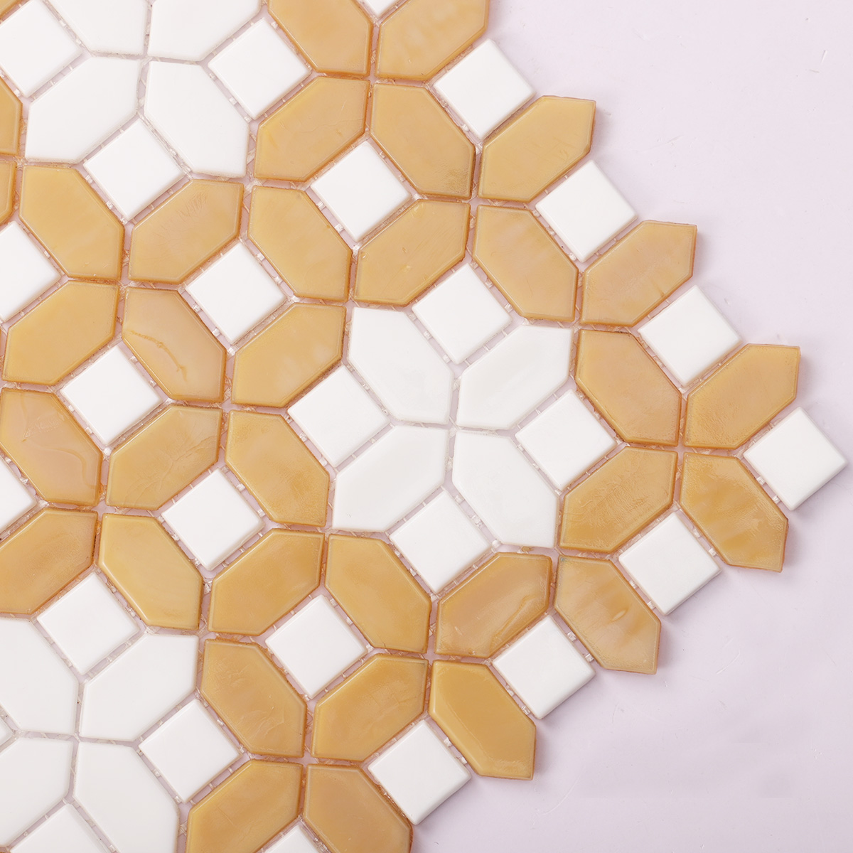 Close-up view of white and deep beige picket polished glass mosaic tiles
