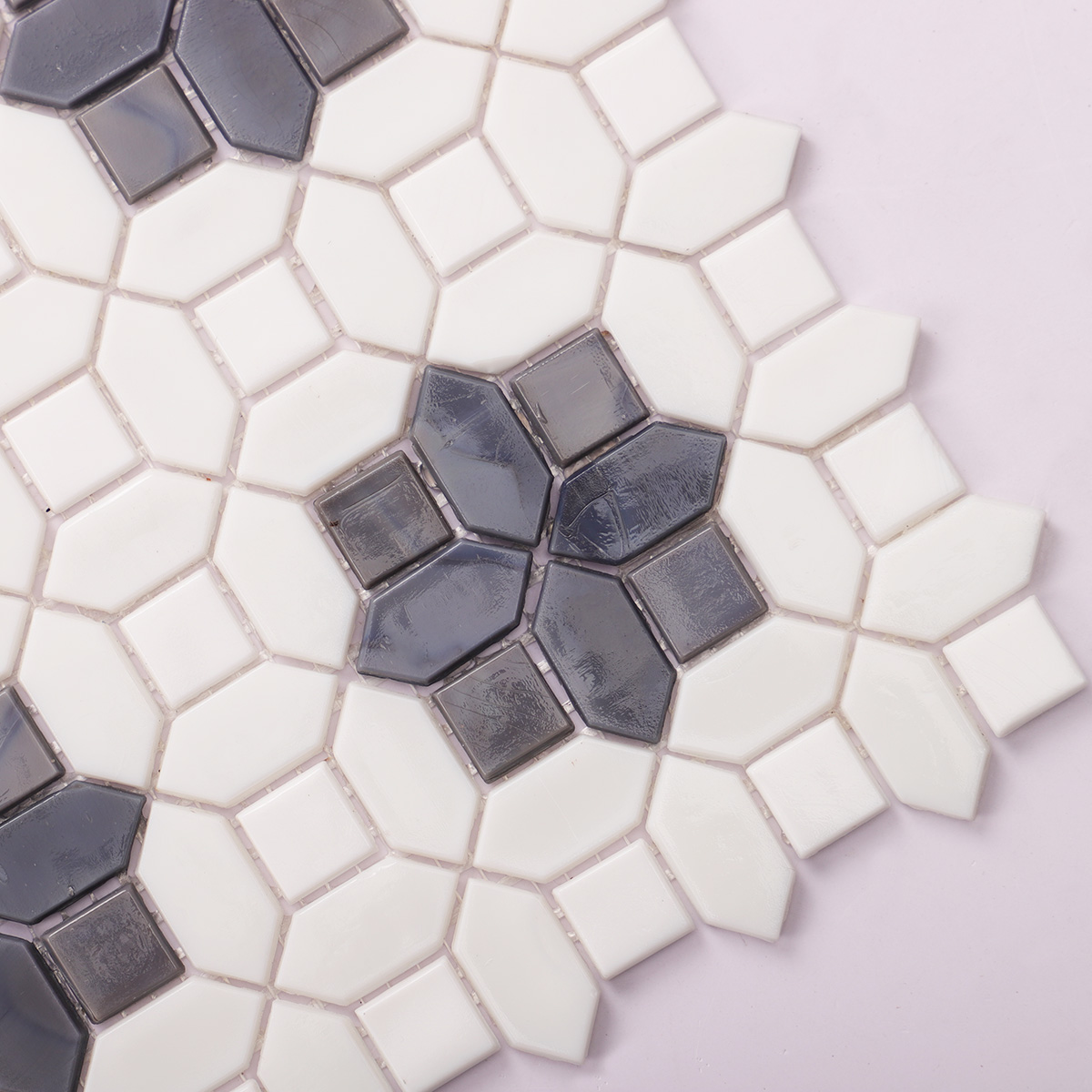 Detailed close-up of gray and white glass picket mosaic tiles
