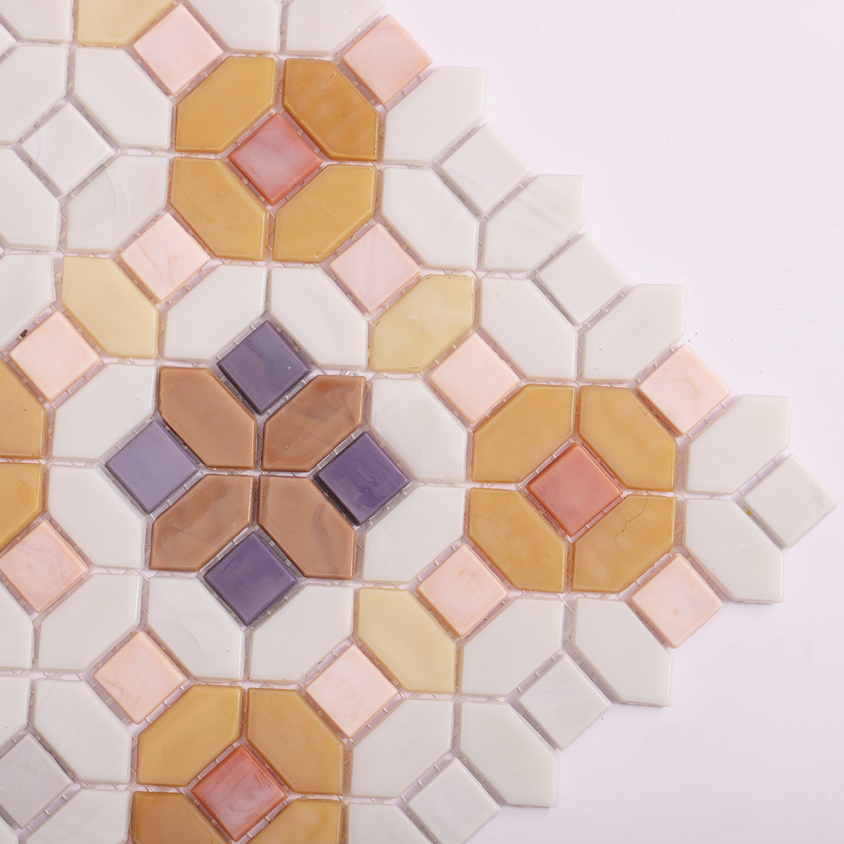 Detailed close-up of floral orange and white glass mosaic tiles