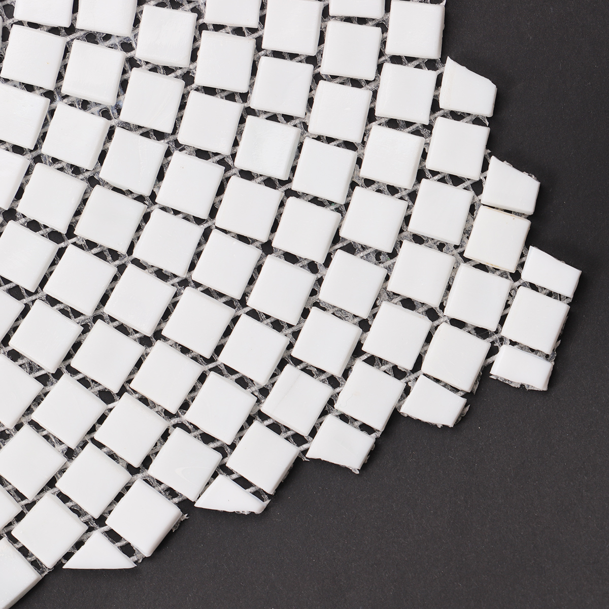 Detailed close-up of white glass mosaics with hand-cutting art