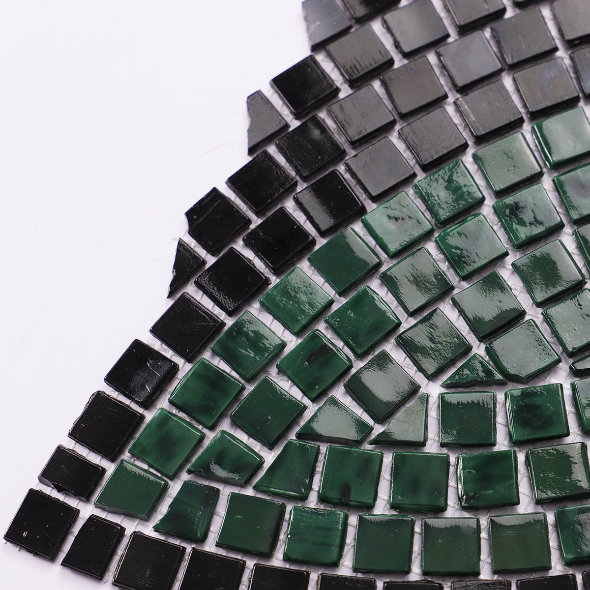 Detailed close-up of green and black glass mosaic pattern wall art