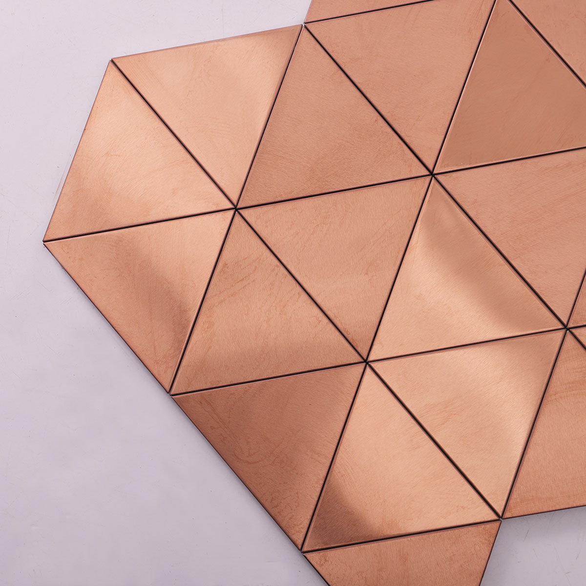 Close-up of rose gold triangle stainless steel mosaic tiles