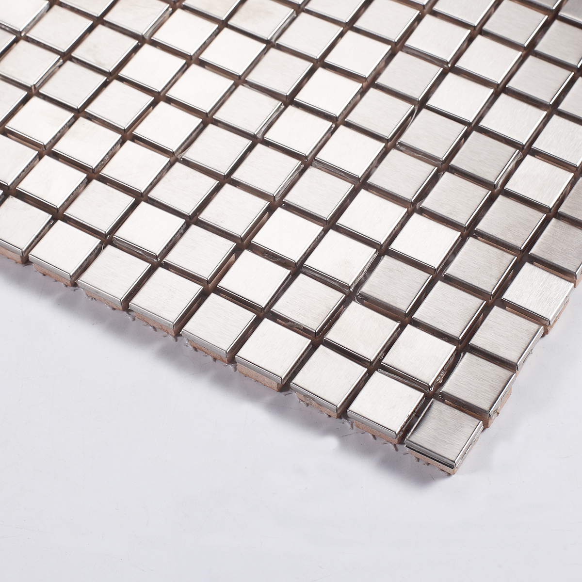 Close-up view of square silver stainless steel mosaic wall tiles.
