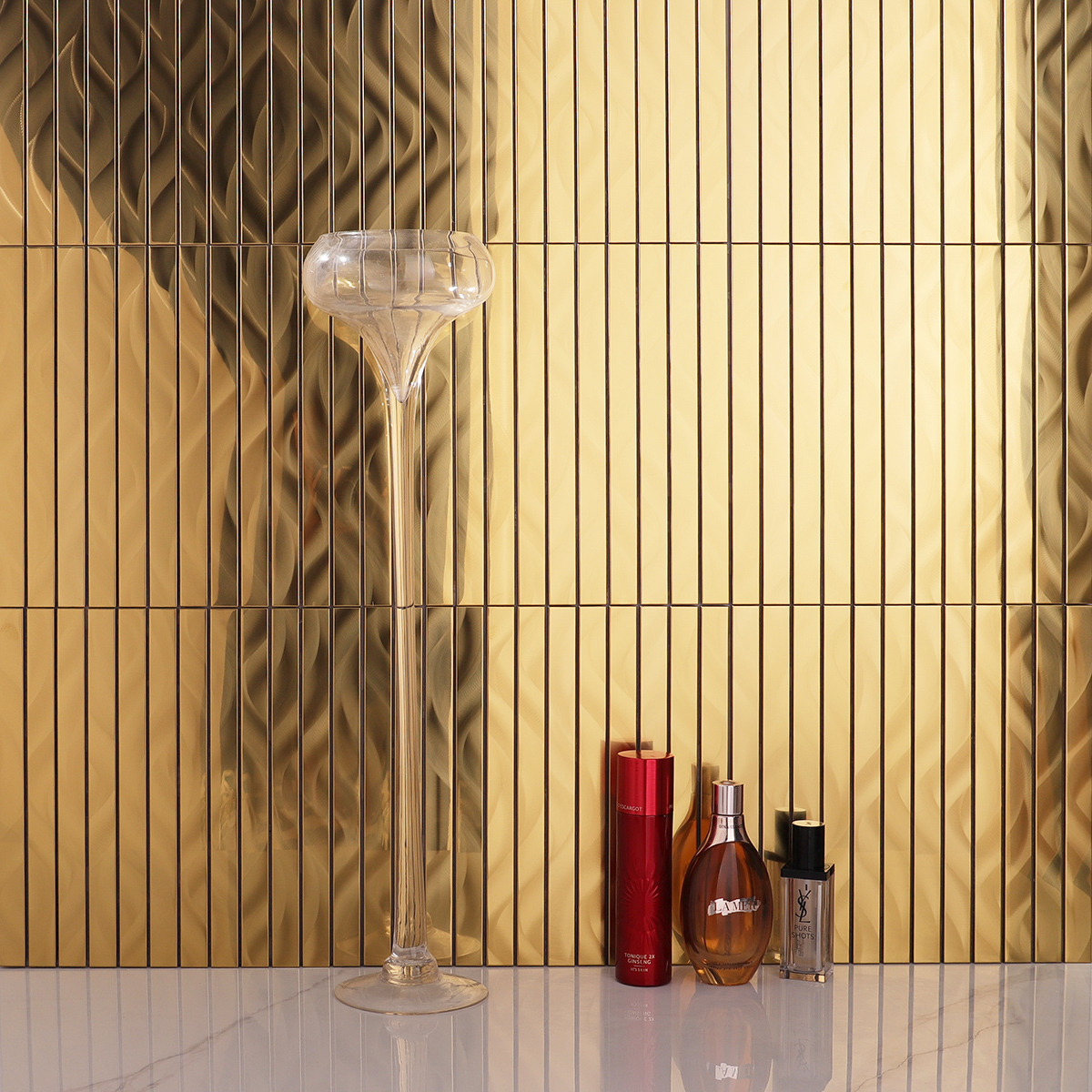 Scene of gold stainless steel strip brick mosaic wall tiles paired with white floor tiles.