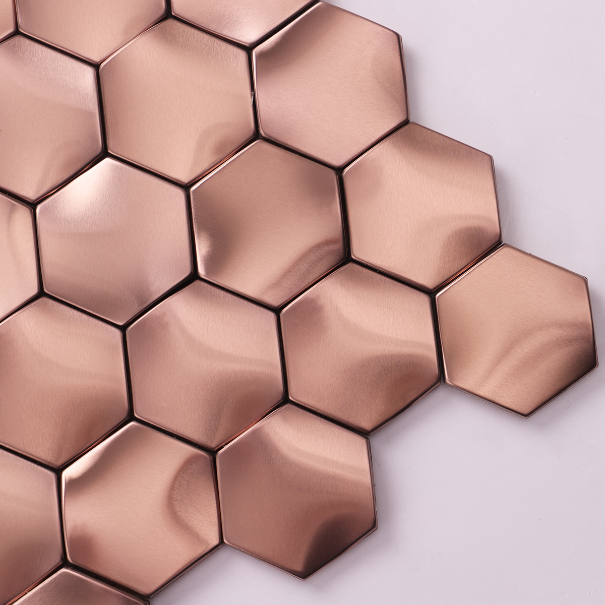 Close-up of rose gold 3D hexagon stainless steel mosaic tiles.