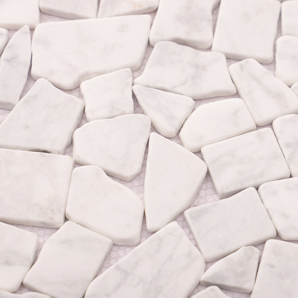 Close-up of cracked white Carrara marble mosaic tile