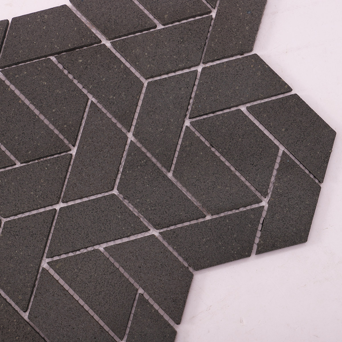 Detailed close-up of black marble mosaic bathroom floor tiles