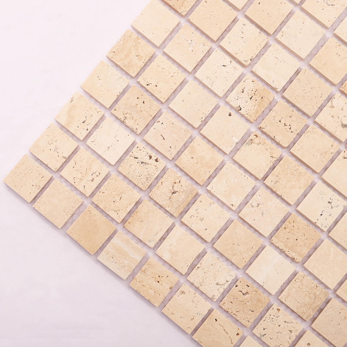 Detailed close-up of light honed square mosaic travertine.