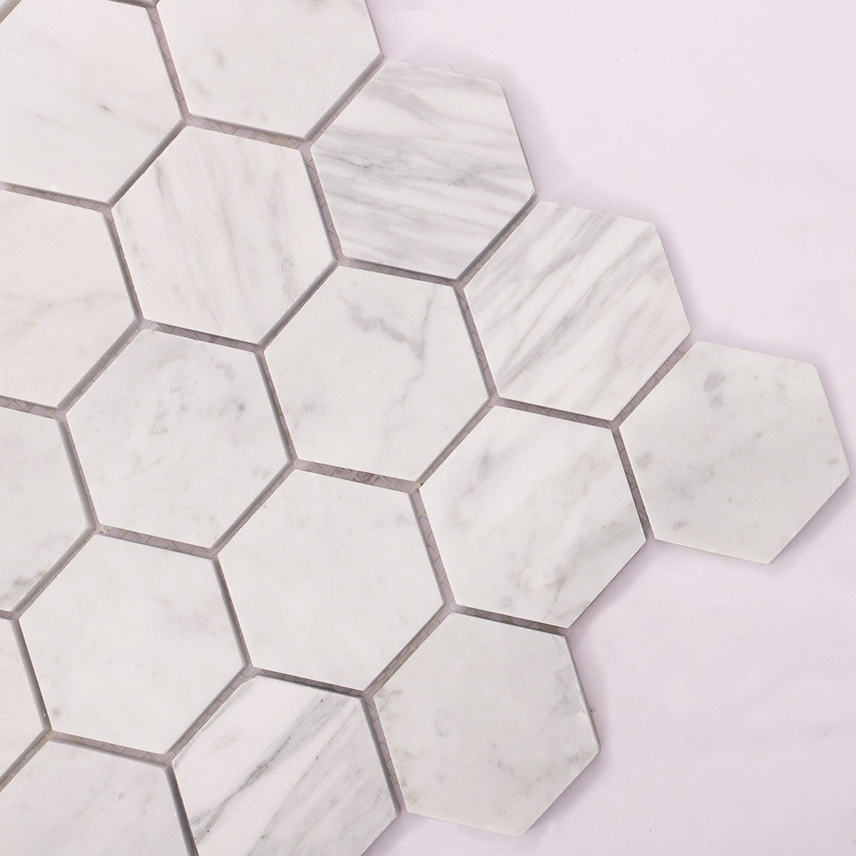 Close-up of Carrara white hexagon marble mosaic tiles.