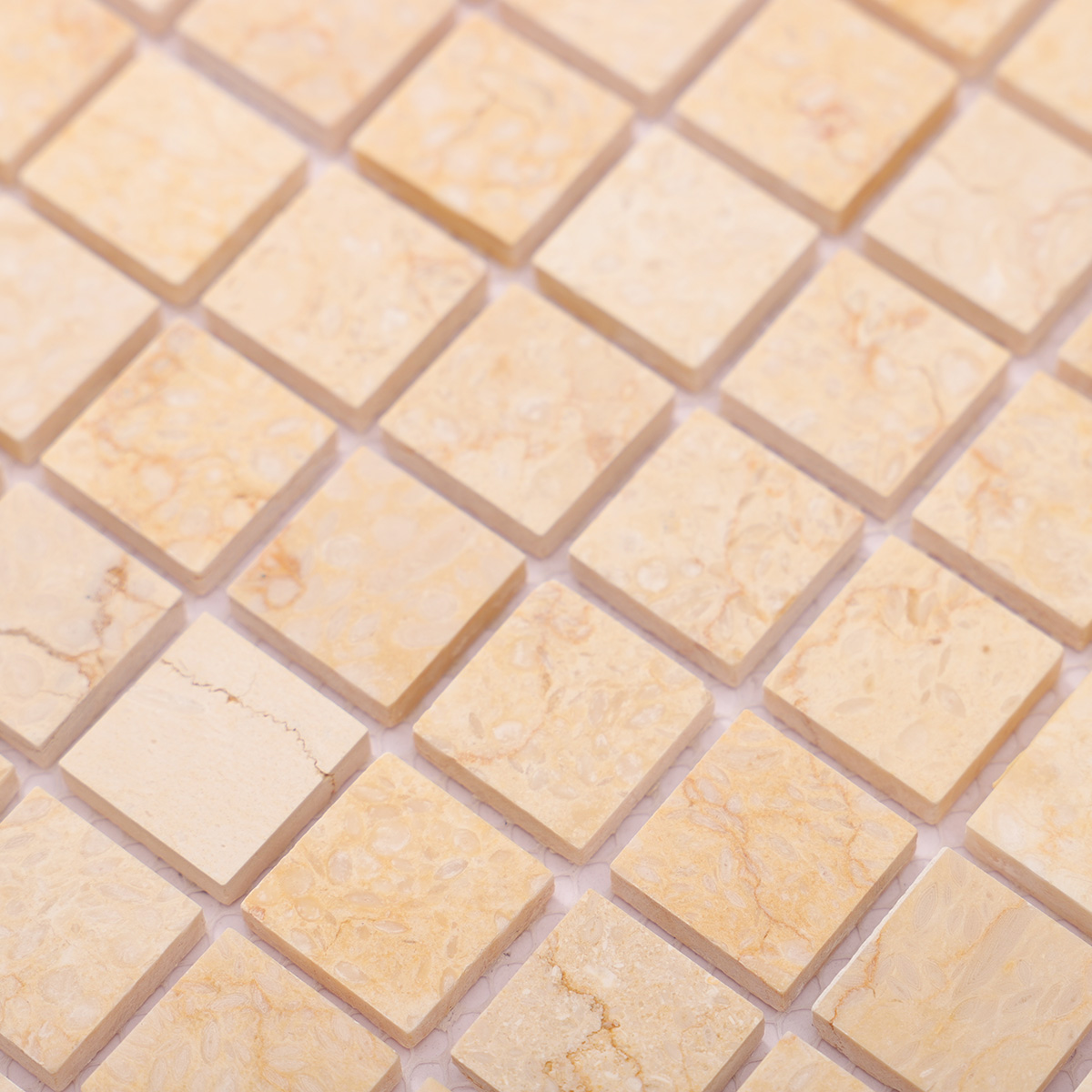 Close-up of Crema Marfil square marble mosaic tiles.
