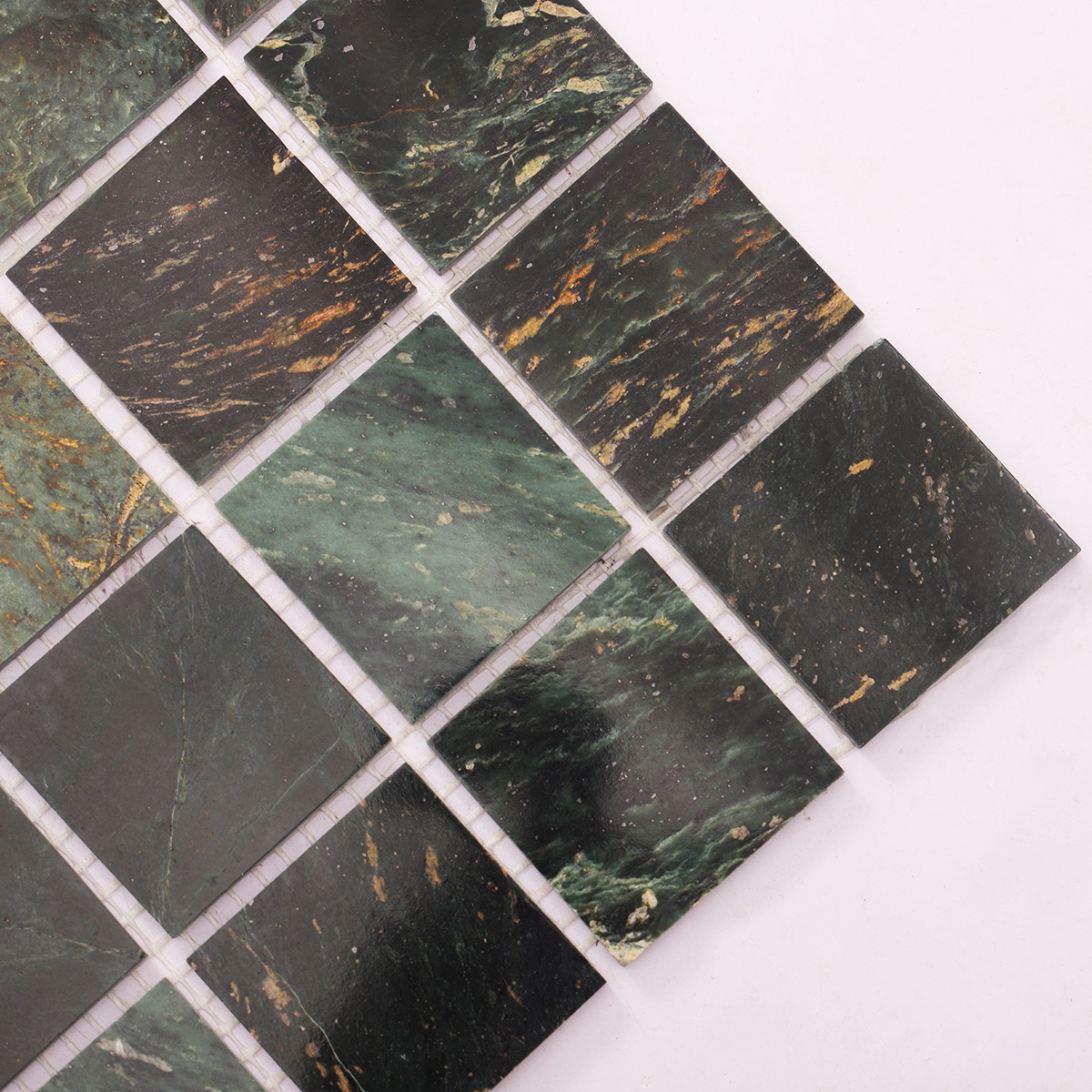 Close-up of Empress Green square marble mosaic tiles.