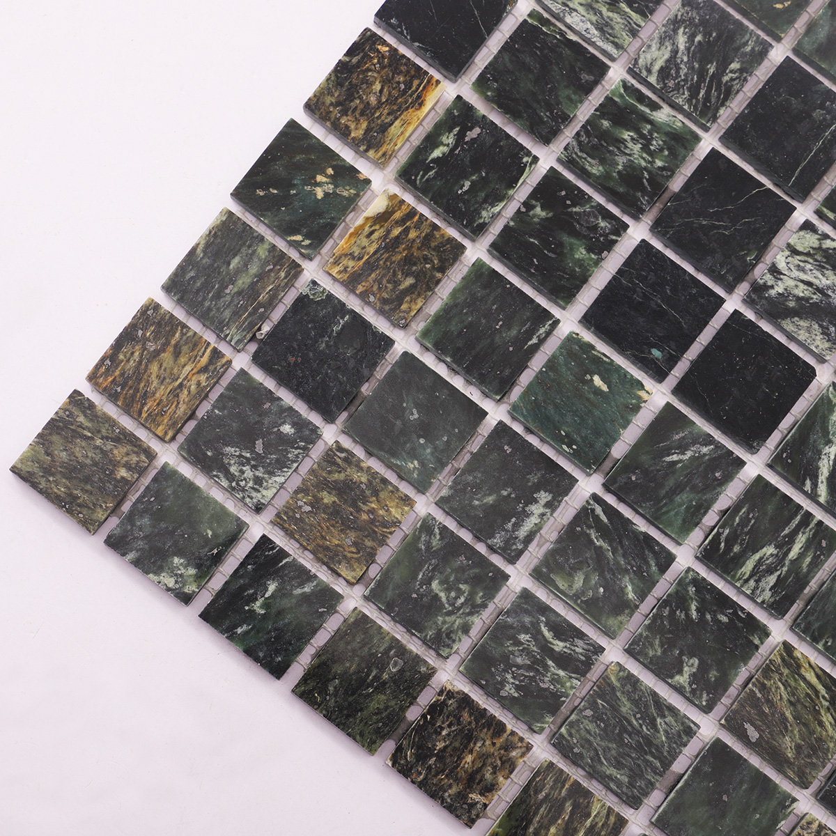 Detailed close-up of Empress Green marble mosaic stone tiles.