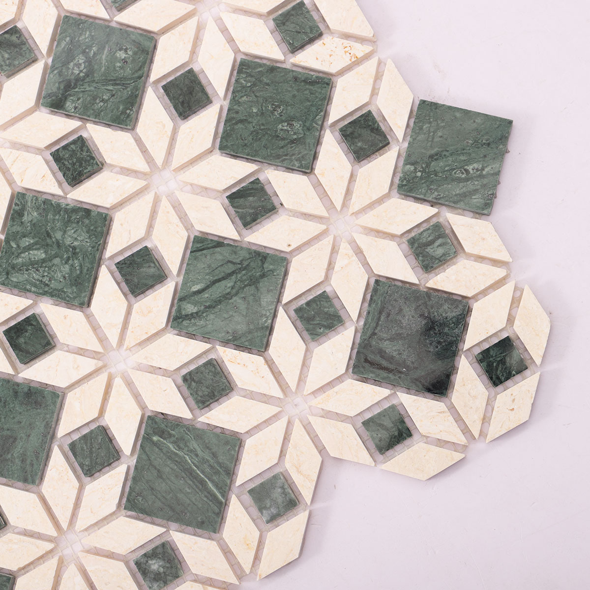 Detailed close-up of green mixed beige marble mosaic natural stone tiles.