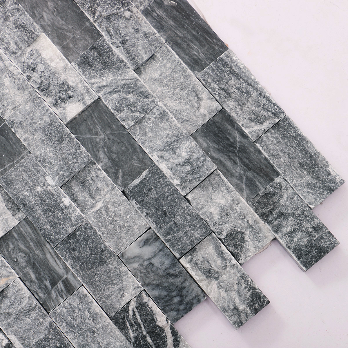 Close-up of gray split face marble mosaic wall tiles.