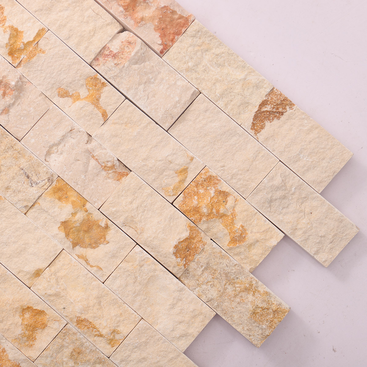 Detailed close-up of Crema Marfil face stone mosaic tiles.