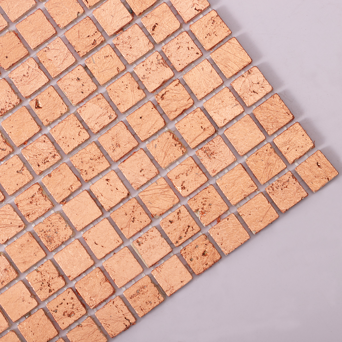Close-up of rose gold foil marble mosaic tiles.