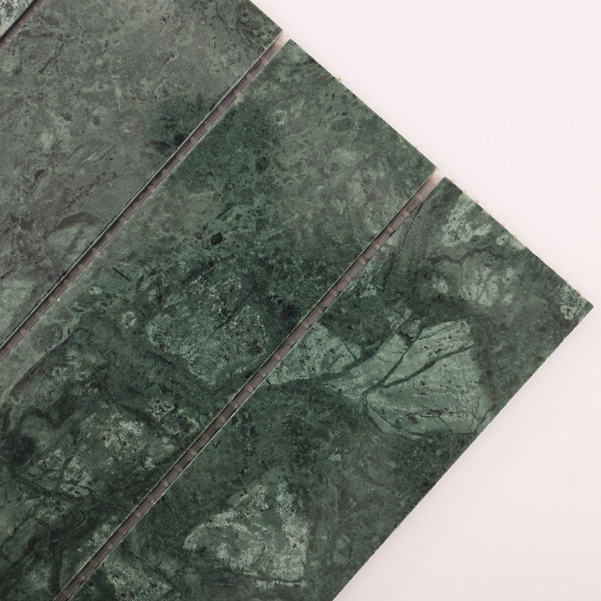 Texture close-up of long strip dark green marble mosaic tiles.