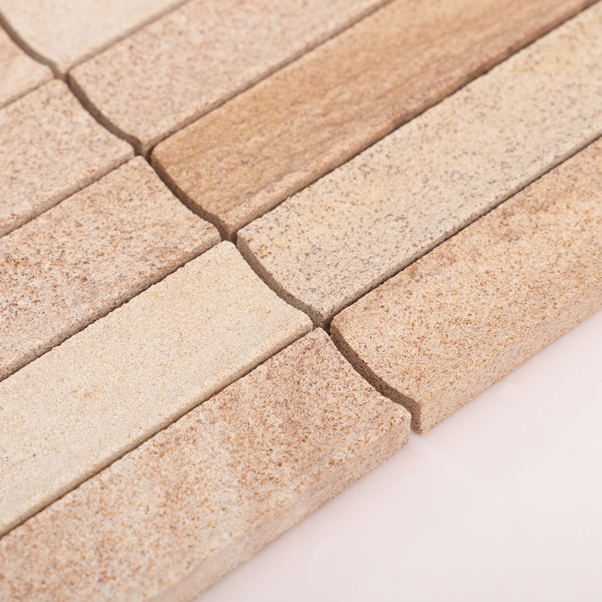 Close-up side view of travertine concave honed fluted strip mosaic tiles, showing thickness.