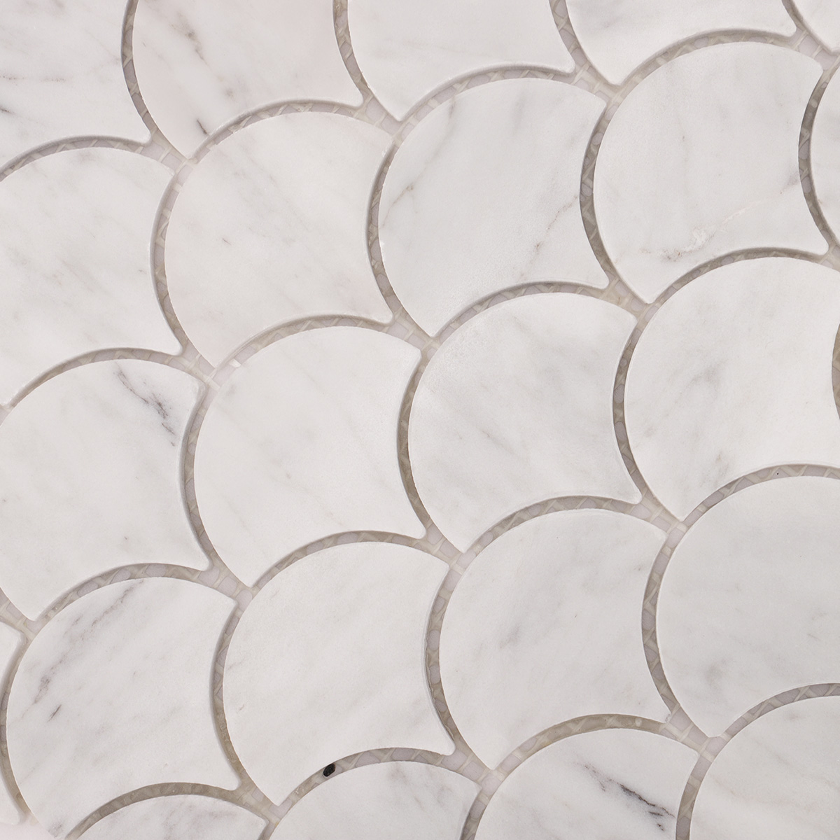 Detailed close-up of fish scale fan shape Carrara white marble polished mosaic tiles