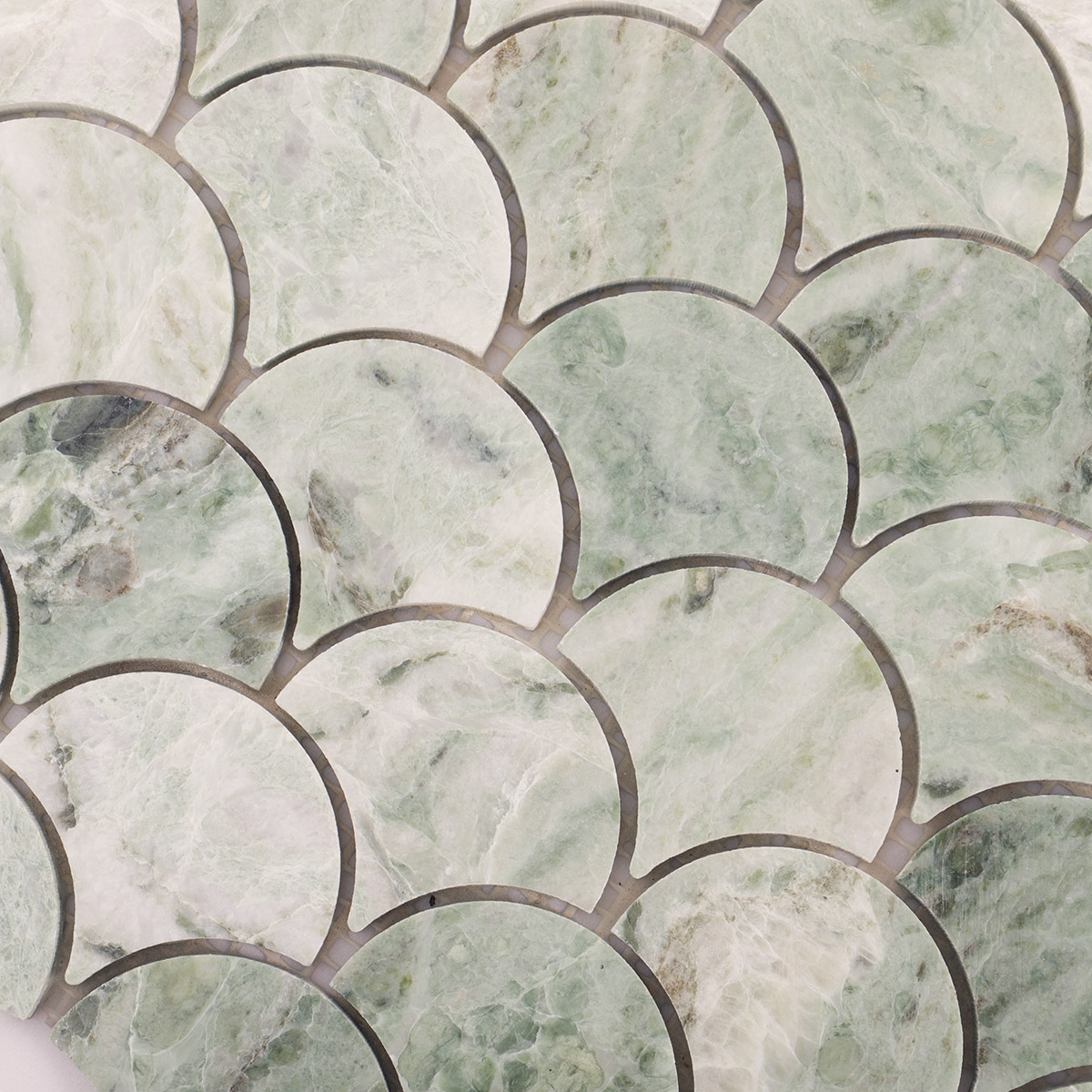 Close-up view of emerald green marble fish scale mosaic tiles.