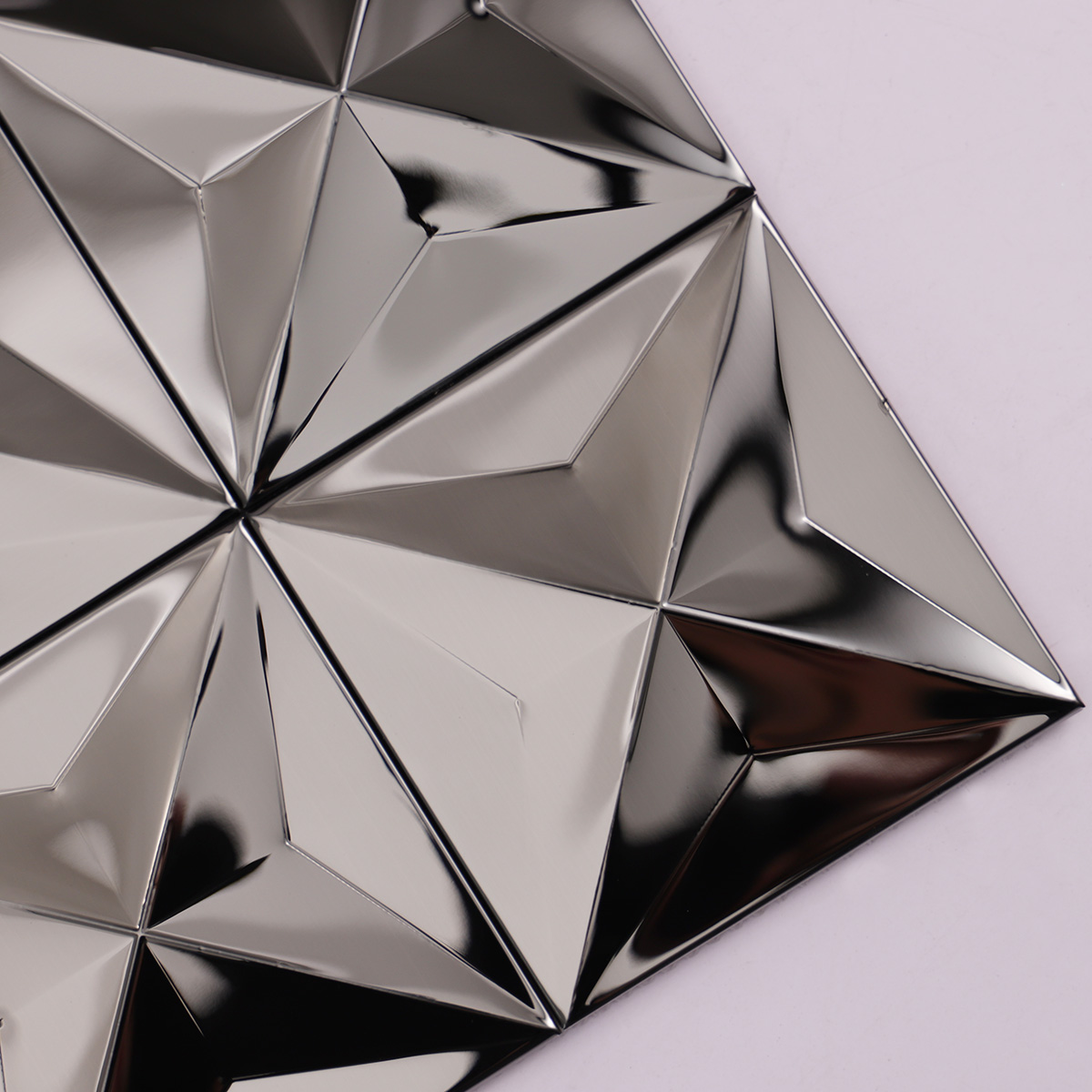 Close-up of black 3D mirror metallic mosaic tiles