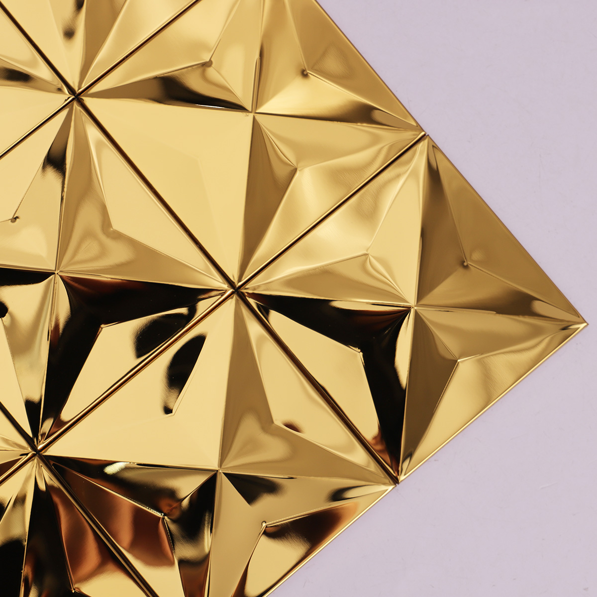 Close-up of 3D gold stainless steel mosaic tiles.