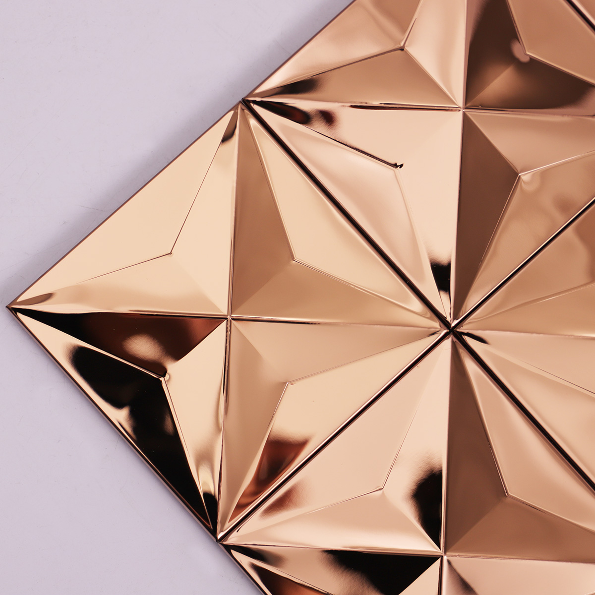 Close-up of rose gold 3D stainless steel metal mosaic tiles.