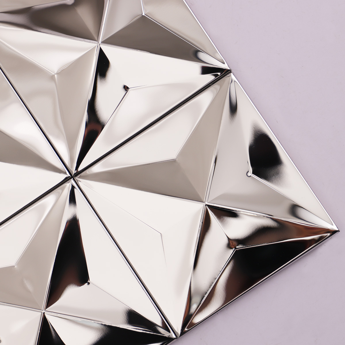 Close-up of 3D silver mirror stainless steel square metal mosaic tiles