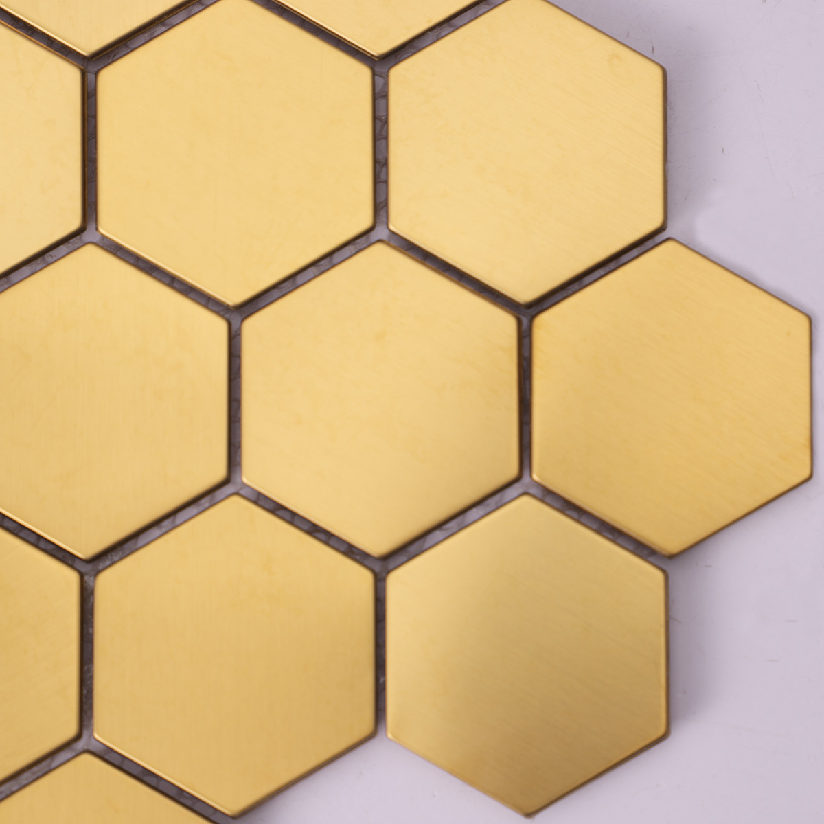 Close-up of hexagon gold stainless steel mosaic wall tiles.