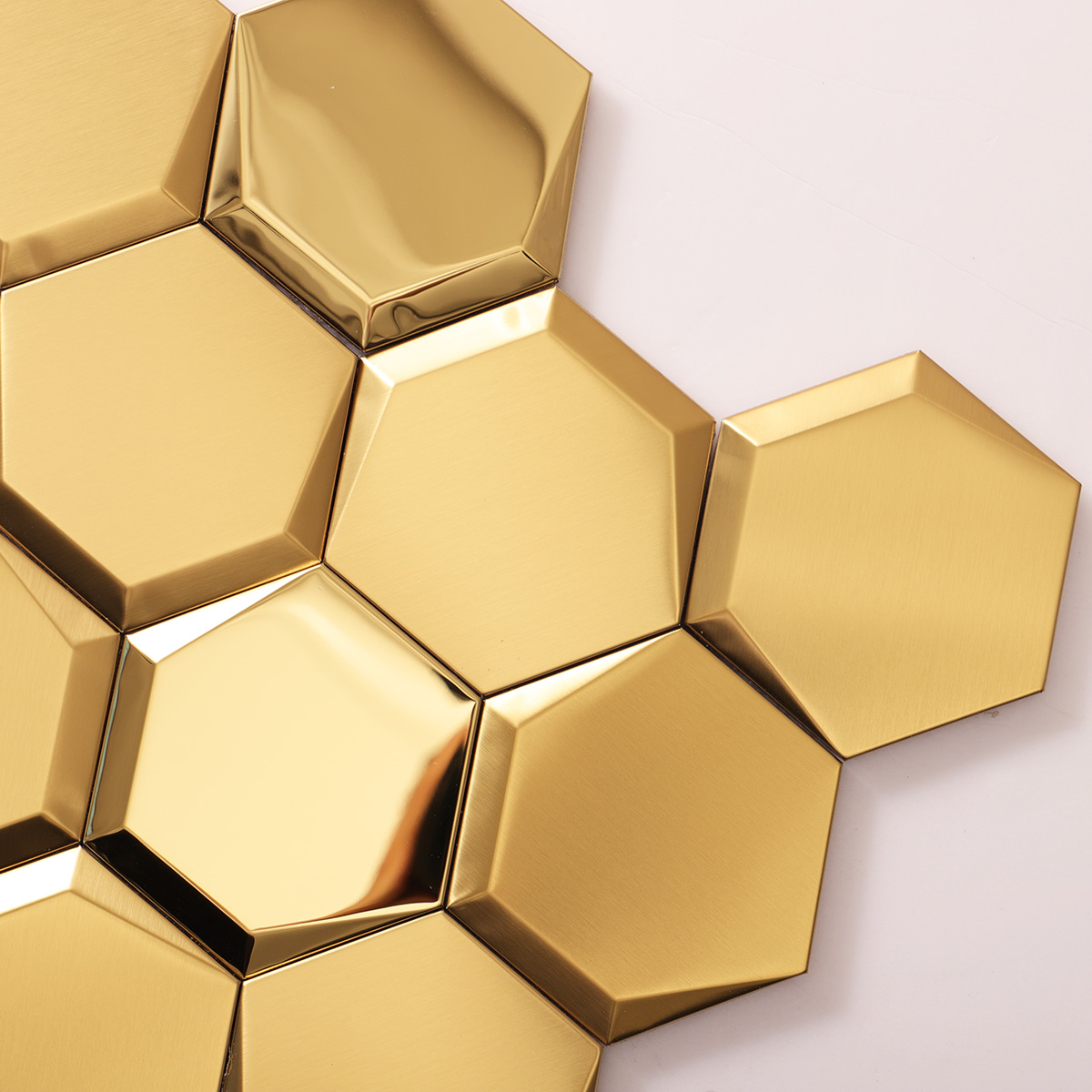 Close-up view of mirror hexagon gold stainless steel mosaic tiles.