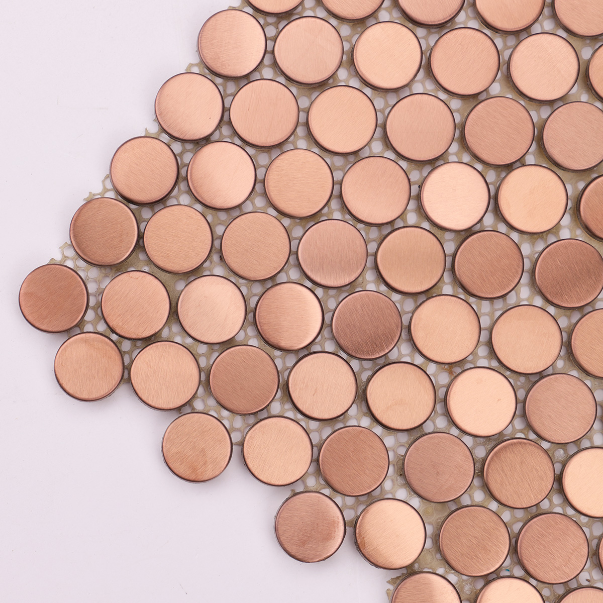 Close-up of rose gold penny rounds stainless steel metal mosaic tiles