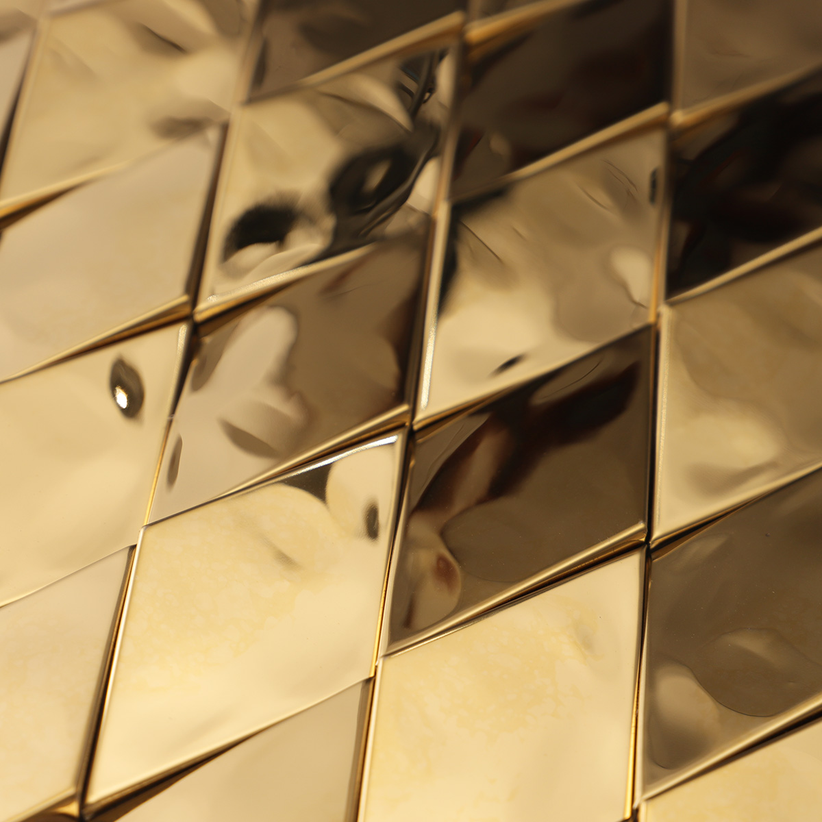 Close-up view of gold diamond 3D stainless steel metal mosaic wall tiles.