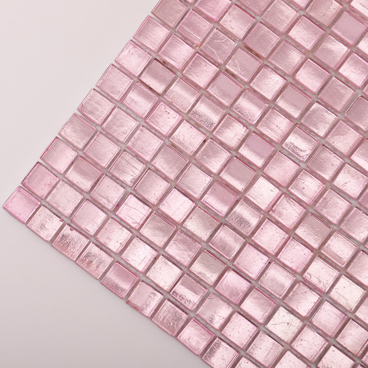 Detailed close-up of pink metallic foil glass mosaic tiles